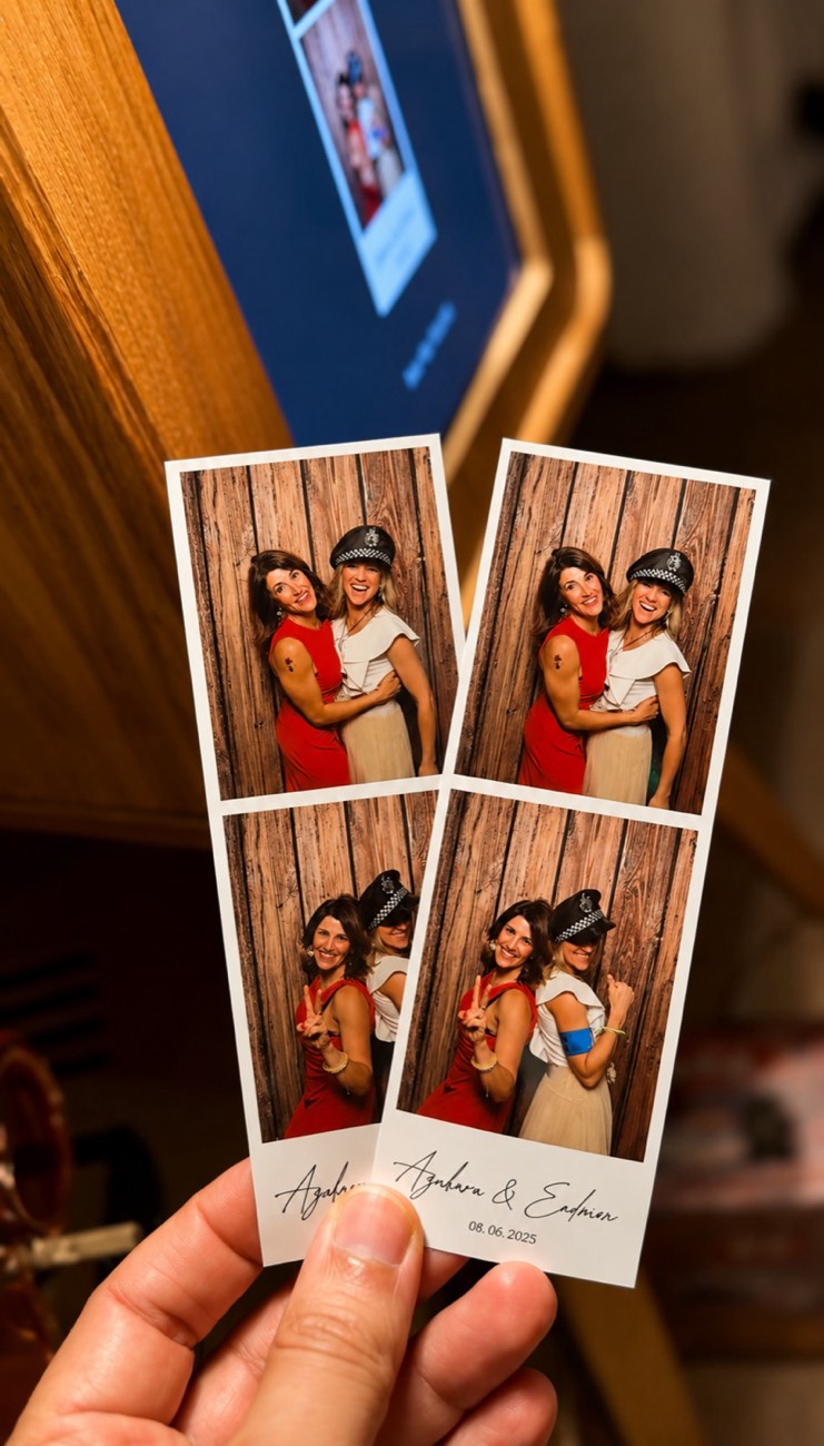 Guests posing in the photobooth with mafia props at the L'Alquería Nova wedding